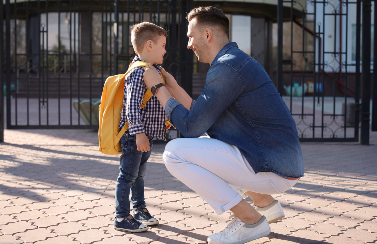 Young Man Saying Goodbye To His Little Child Near School