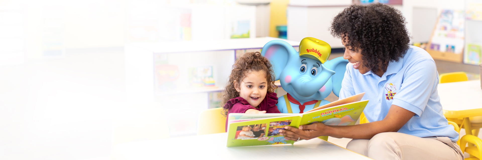 Teacher and child read book together